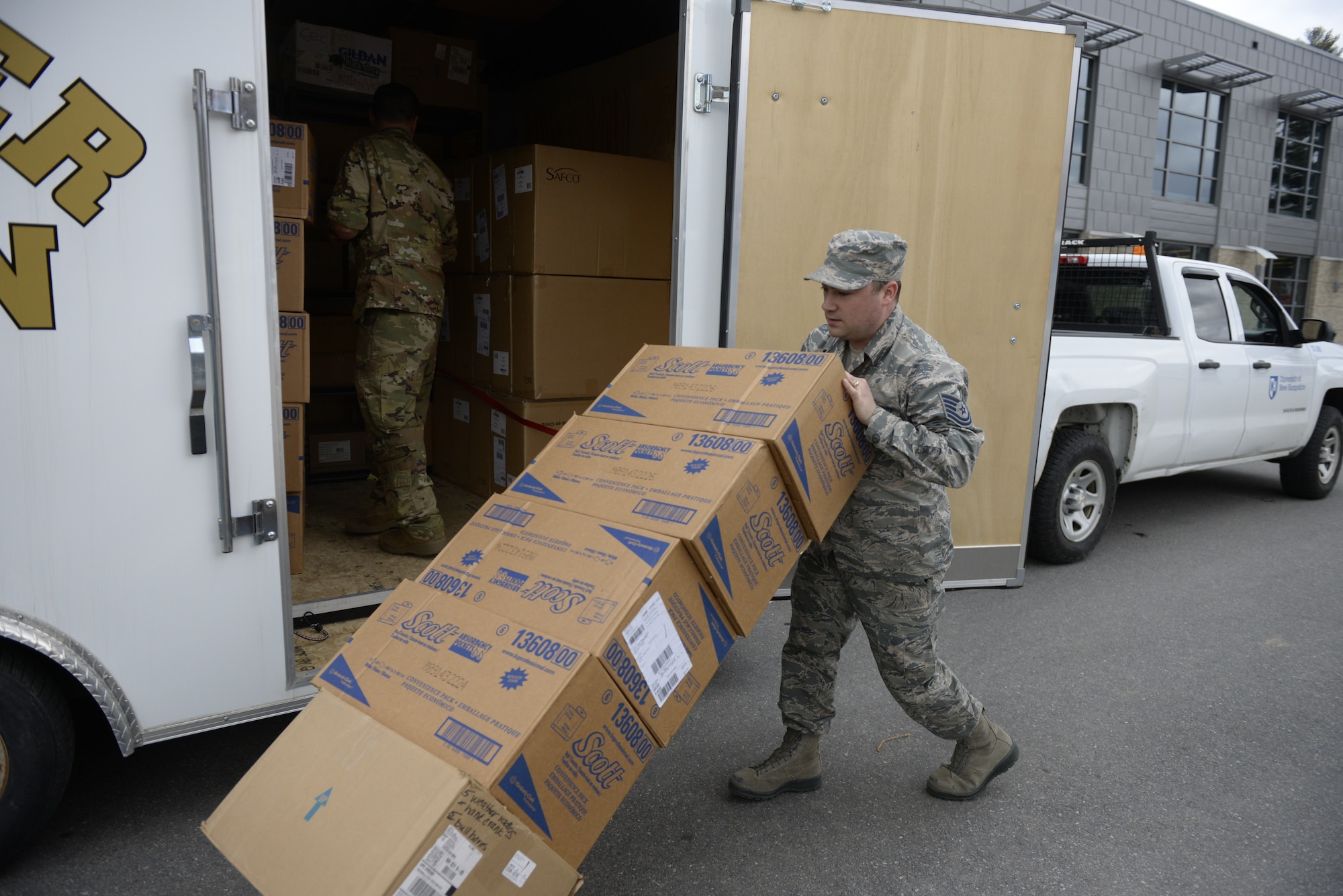 Tech. Sgt. Lance Whitehill, 157th Civil Engineers Squadron, New Hampshire Air National Guard, offloads supplies at the Hamel Recreation Center, University of New Hampshire, March 25, 2020. The facility will augment area hospitals treating COVID-19 cases, if necessary. It is one of nine the NHNG plans to set up and manage across the state. (U.S. Air National Guard photo by Tech. Sgt. Aaron Vezeau)