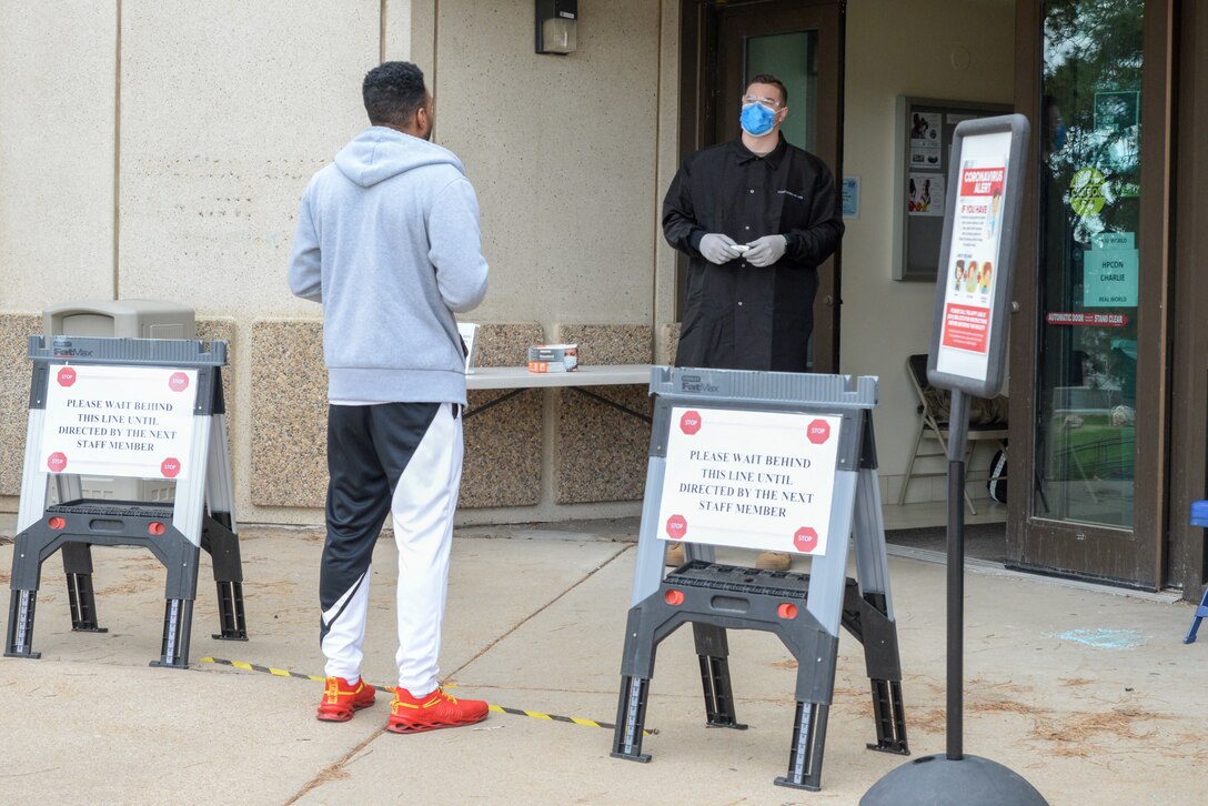 Airman 1st Class Kyle Larson, a medical technicial with 75th Medical Group, screens an incoming patient before entering the Hill Air Force Base, Utah medical clinic March 31, 2020.