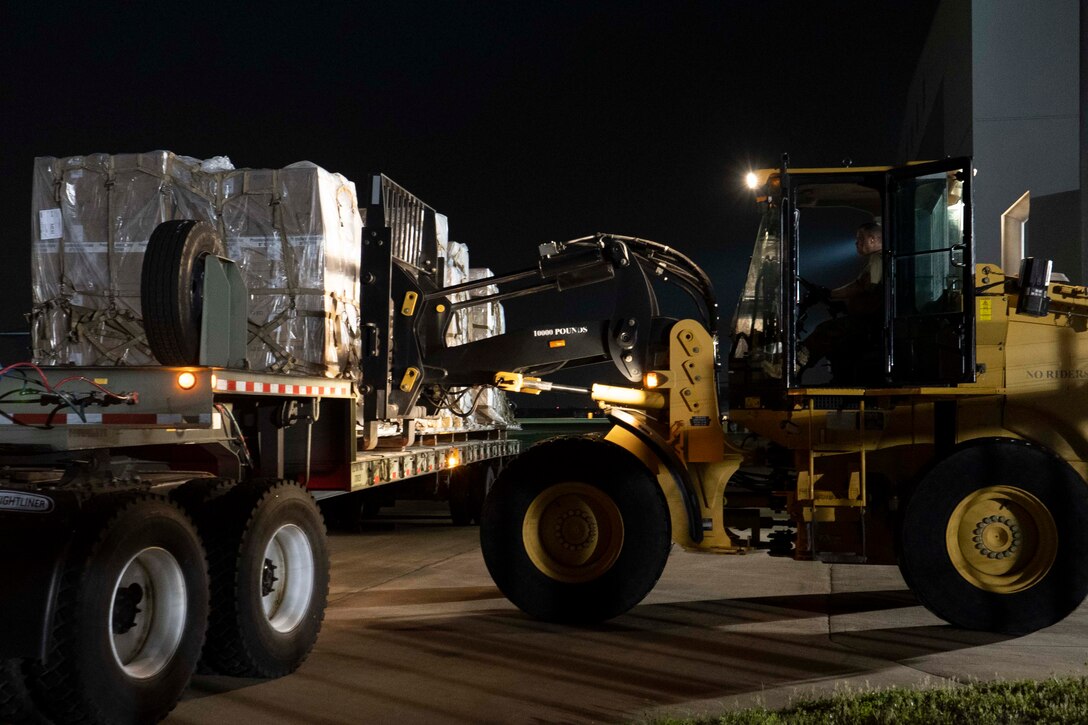 A piece of equipment moves pallets.