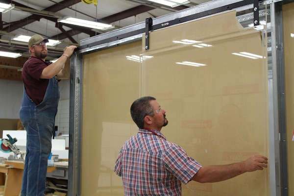 ERDC’s Directorate of Public Works staff work to build two types of mock-up hospital rooms.