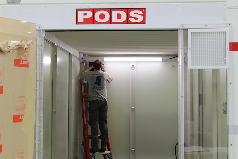 ERDC’s Directorate of Public Works staff work to build two types of mock-up hospital rooms.