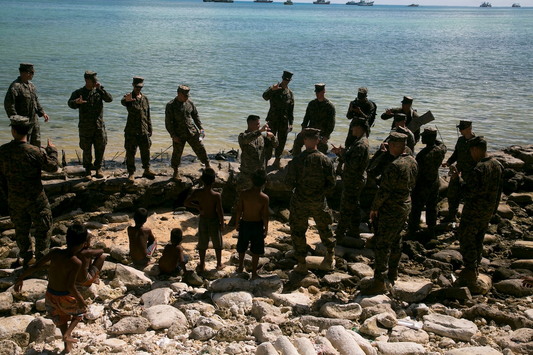 Platoon commander with 2nd Battalion, 8th Marine Regiment, gives professional military education class explaining strategy the Marines of 2/8 used when they landed on Red Beach 3 in November 1943, Betio, Kiribati, July 22, 2018 (U.S. Marine Corps/Timothy Hernandez)