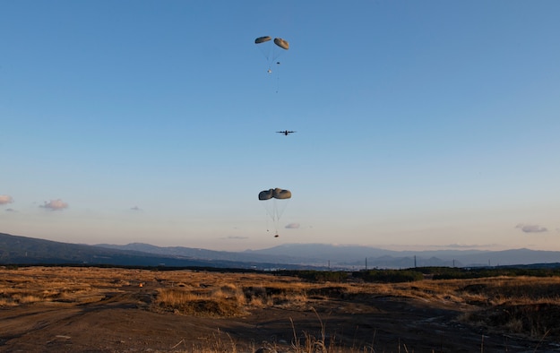 A C-130J Super Hercules, assigned with the 36th Airlift Squadron, Yokota Air Base, Japan, drops bundles at the Combined Arms Training Center, Camp Fuji, Japan