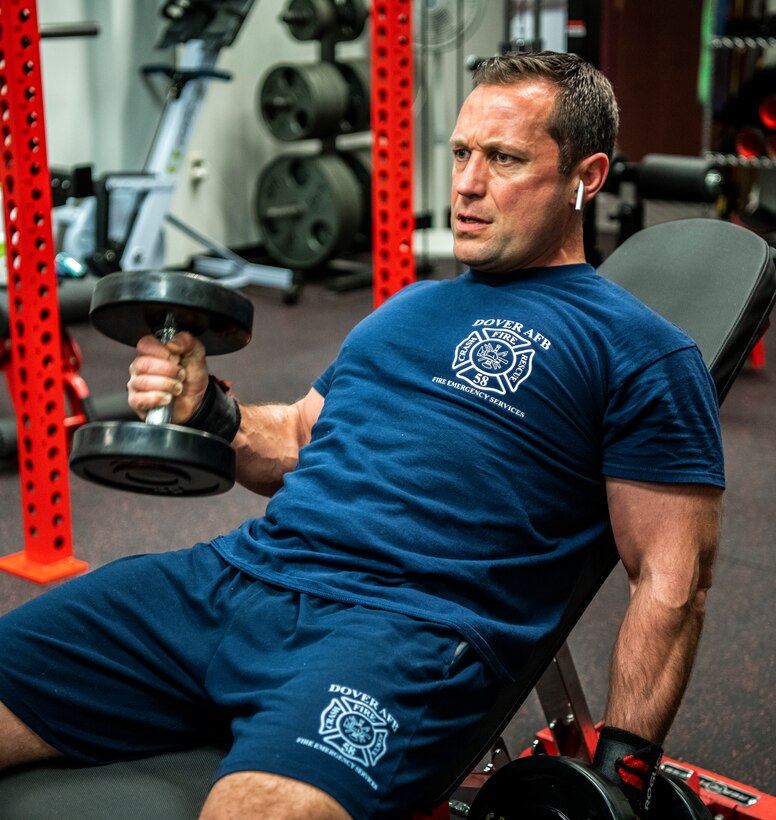 Pete Bortz, 436th Civil Engineer Squadron fire captain, works out at the fire department gym at Dover Air Force Base, Delaware, March 30, 2020. Despite the COVID-19 pandemic and signifcantly reduced manning, Dover AFB fire remains ready for emergencies and to support response efforts. (U.S. Air Force photo by Senior Airman Christopher Quail)