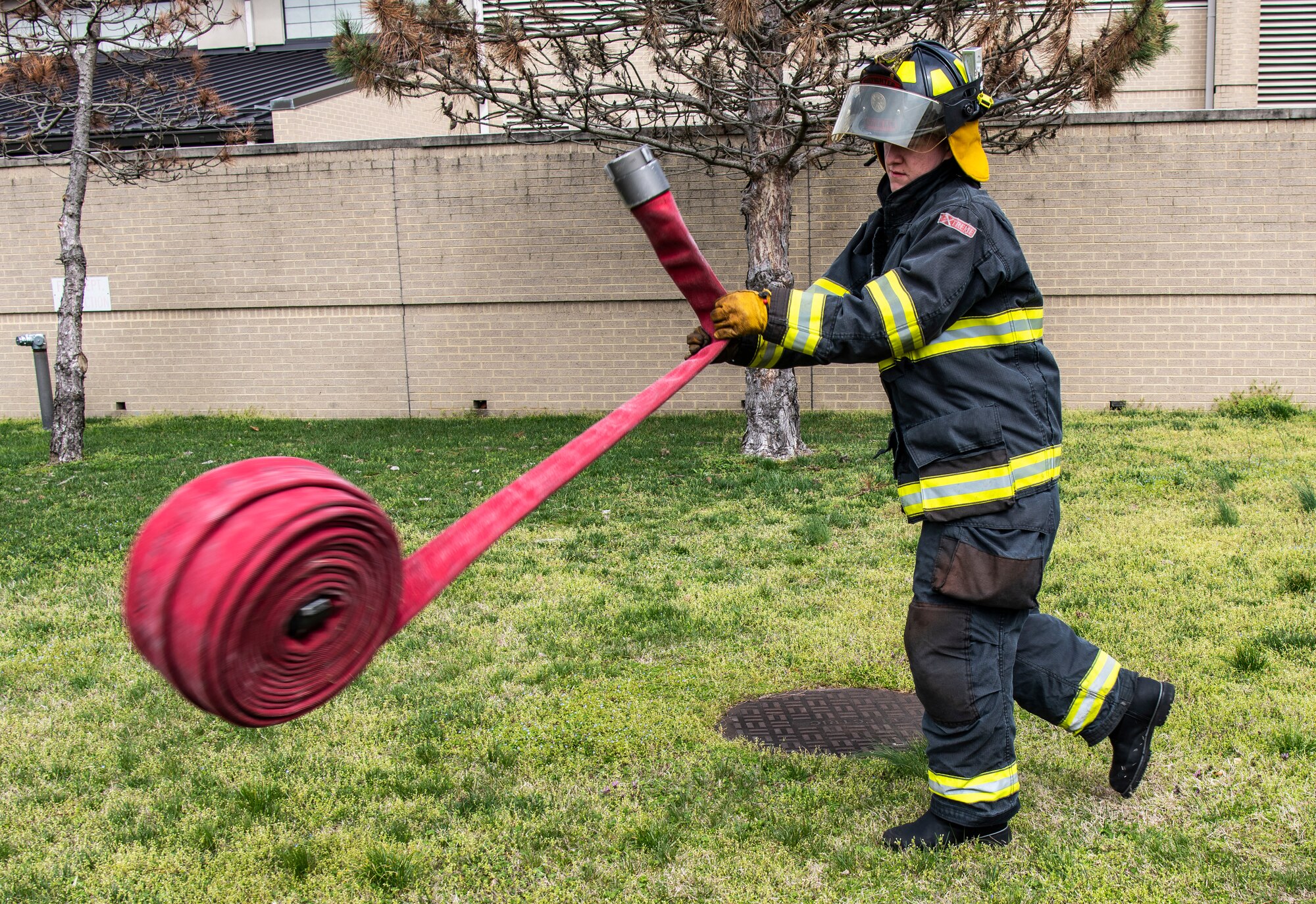 Airman 1st Class Dayton Holtkamp, 436th Civil Engineer Squadron firefighter, inspects a hose at Dover Air Force Base, Delaware, March 30, 2020. Despite the COVID-19 pandemic and signifcantly reduced manning, Dover AFB fire remains ready for emergencies and to support response efforts.  (U.S. Air Force photo by Senior Airman Christopher Quail)