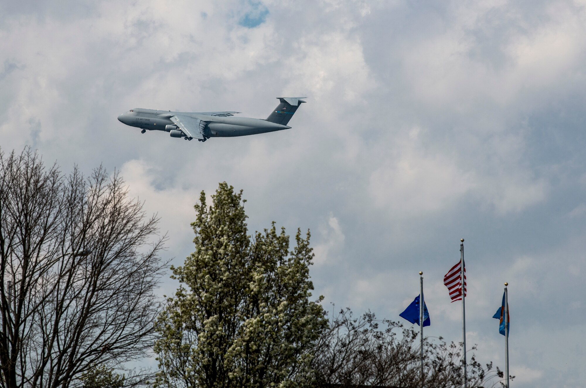 A Dover C-5M Super Galaxy flies over Dover Air Force Base, Delaware, March 30, 2020. Despite the COVID-19 pandemic and significantly reduced manning, aircrews continue to fly in support of global and national response efforts. (U.S. Air Force photo by Senior Airman Christopher Quail)