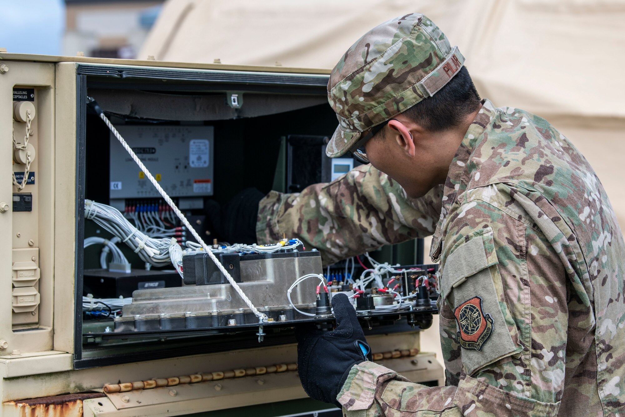 Tech. Sgt. Erickson Pilar, 436th Medical Support Squadron noncommissioned officer in charge of medical maintenance, works on a diesel generator at Dover Air Force Base, Delaware, March 30, 2020. The generator was attached to a tent that was built to prepare for patient overflow due to COVID-19. Dover AFB medical personnel continue to provide care to Airmen and their families, while supporting state and national response efforts. (U.S. Air Force photo by Senior Airman Christopher Quail)