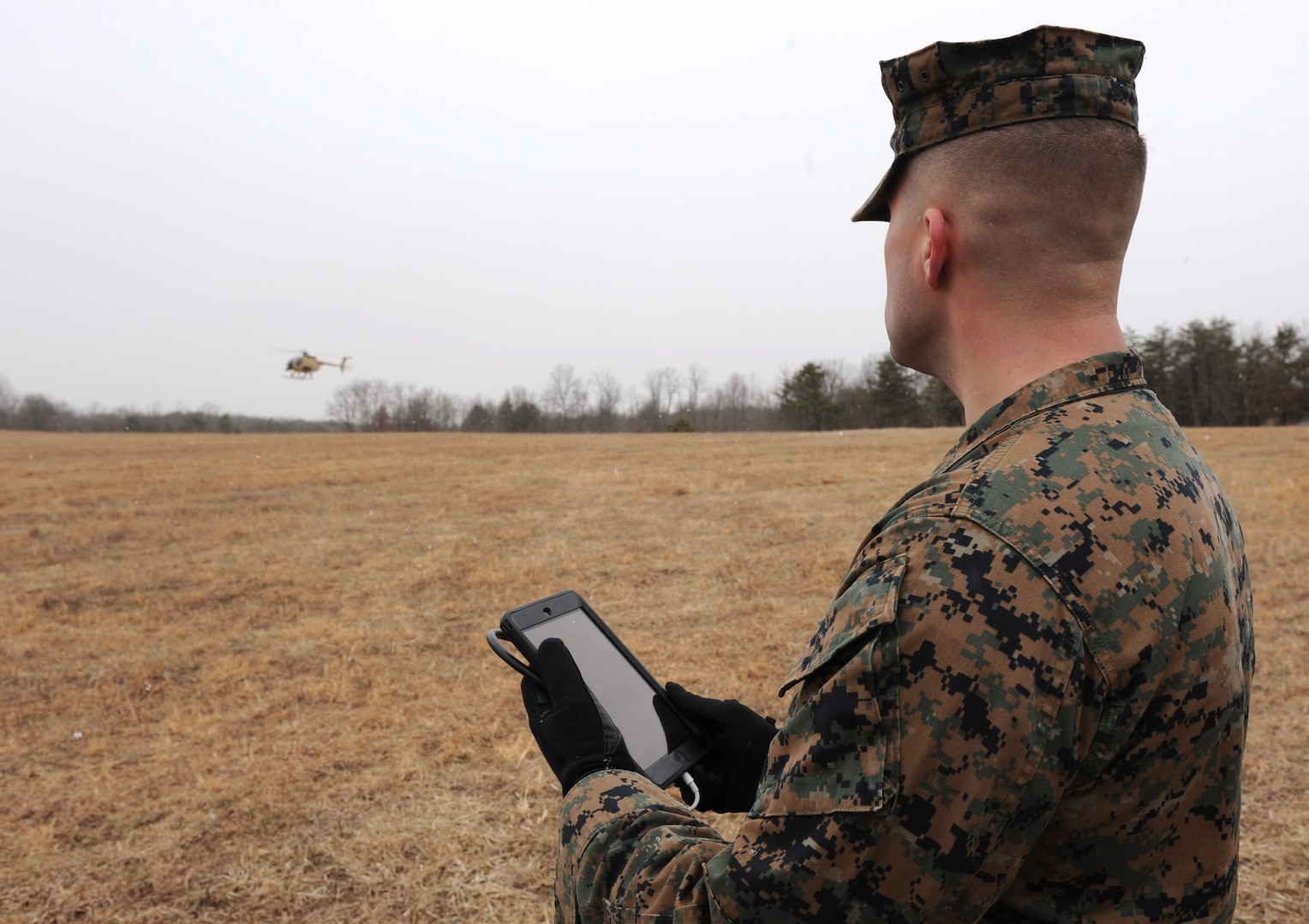 Seaman uses handheld tablet to request resupply during Office of Naval Research demonstration of Autonomous Aerial Cargo/Utility System, giving
capability to helicopters for unmanned flight, Quantico, Virginia, February 25, 2014 (U.S. Navy/John F. Williams)