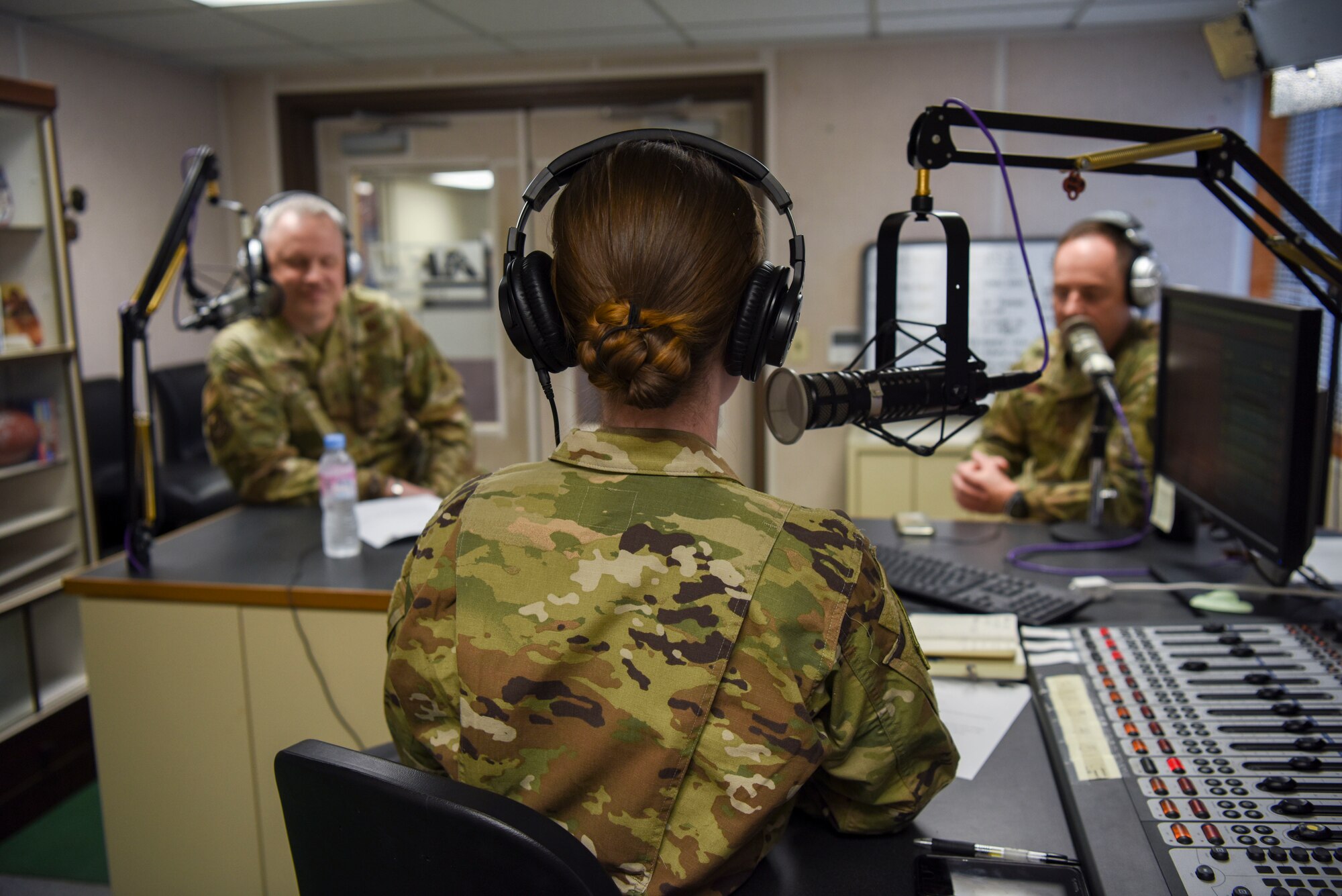 U.S. Air Force Chief Master Sgt. Philip Hudson, 7th Air Force command chief, speaks with Senior Airman Oriana Beard, Armed Forces Network broadcaster, during his visit at Kunsan Air Base, Republic of Korea, March 26, 2020. Hudson learned about how the 8th Fighter Wing is ensuring the safety of Airmen on the base while accomplishing the mission. (U.S. Air Force photo by Senior Airman Jessica Blair)