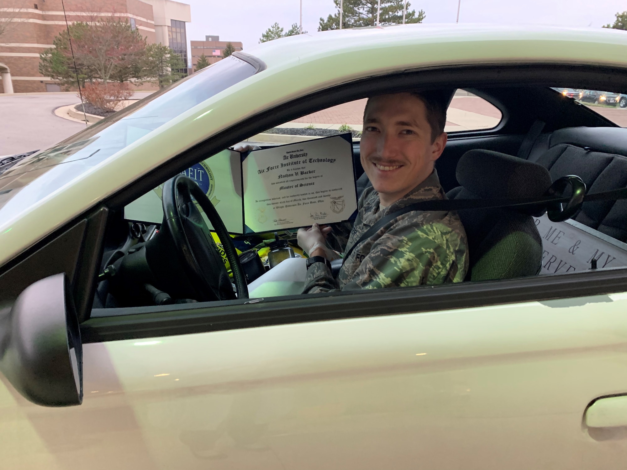 Second Lt. Nathan Barker was presented his diploma at an AFIT ‘drive thru’ as part of his out processing. Due to current concerns of COVID-19, a commencement ceremony for 2020 graduates was not held. About 60 diplomas were presented to students during the out processing. AFIT’s Graduate School of Engineering and Management awarded 236 master’s degrees and seven doctorate degrees in science, technology, engineering and math fields. Two graduate student’s received dual master’s degrees. (Courtesy photo)