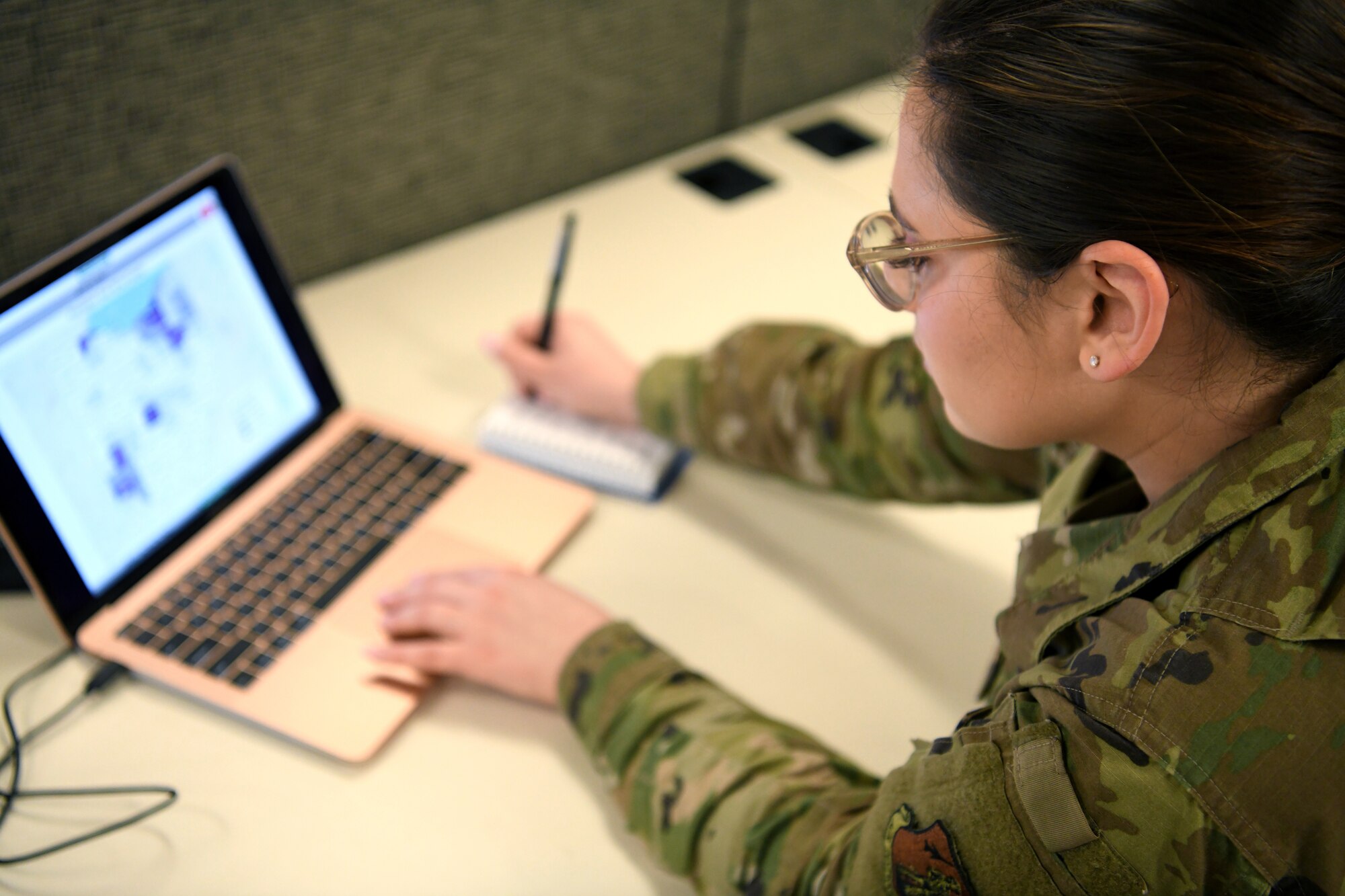 Senior Airman Elise, an analyst assigned to the 178th Wing, analyzes a map of counties throughout Ohio March 30, 2020, at the Defense Supply Center Columbus. Elise is serving on the Joint Task Force 37 collecting data on coronavirus cases, hospitalizations and available hospital resources across the state, as well as providing weather and route information for the JTF-37 task forces supporting local food banks.