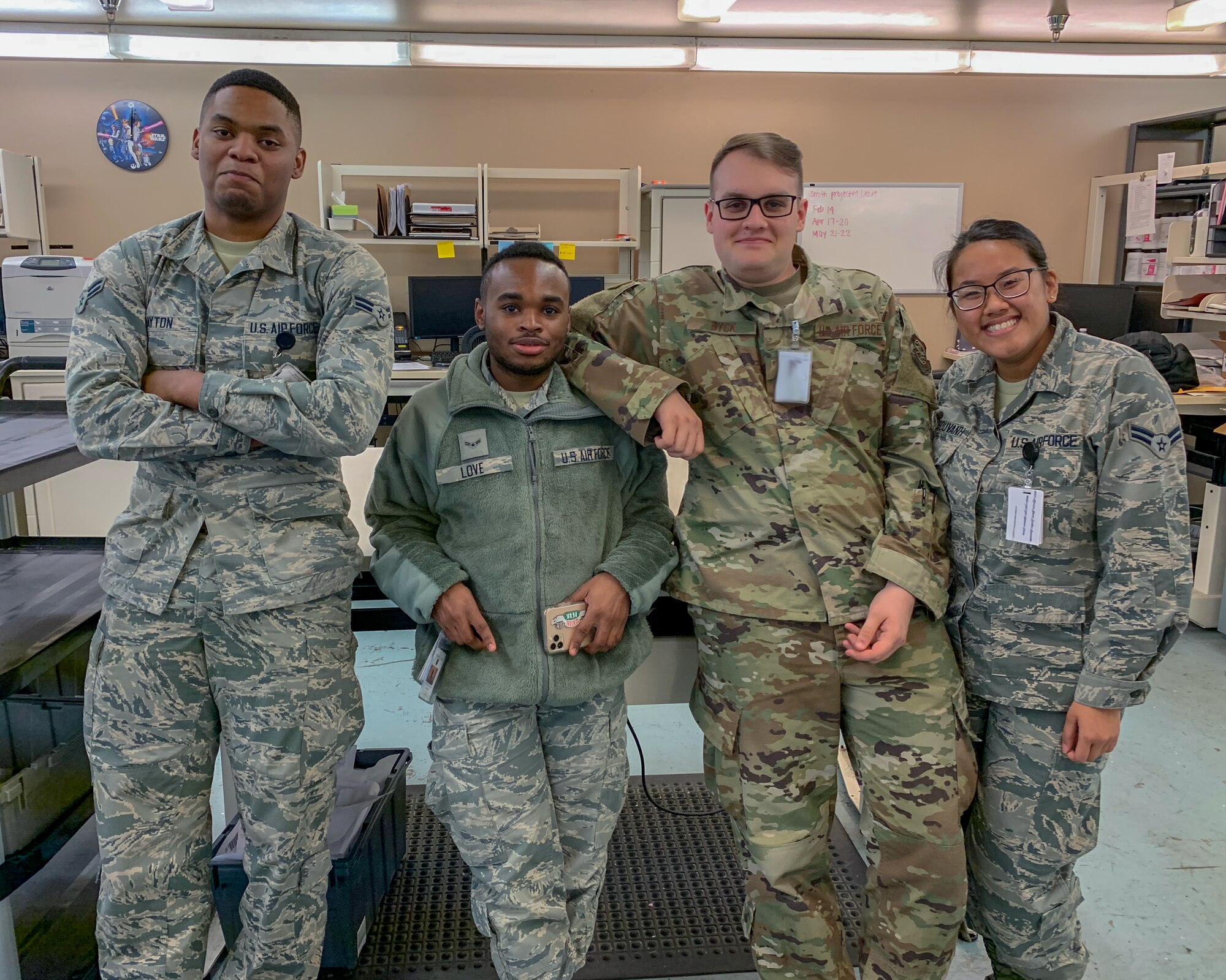 Senior Airman Elizabeth Soisouvanh poses with her coworkers. (Courtesy photo)