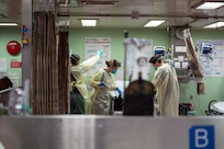Sailors on the USNS Mercy work on a patient.