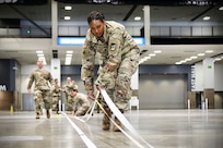 A soldier lays down tape.