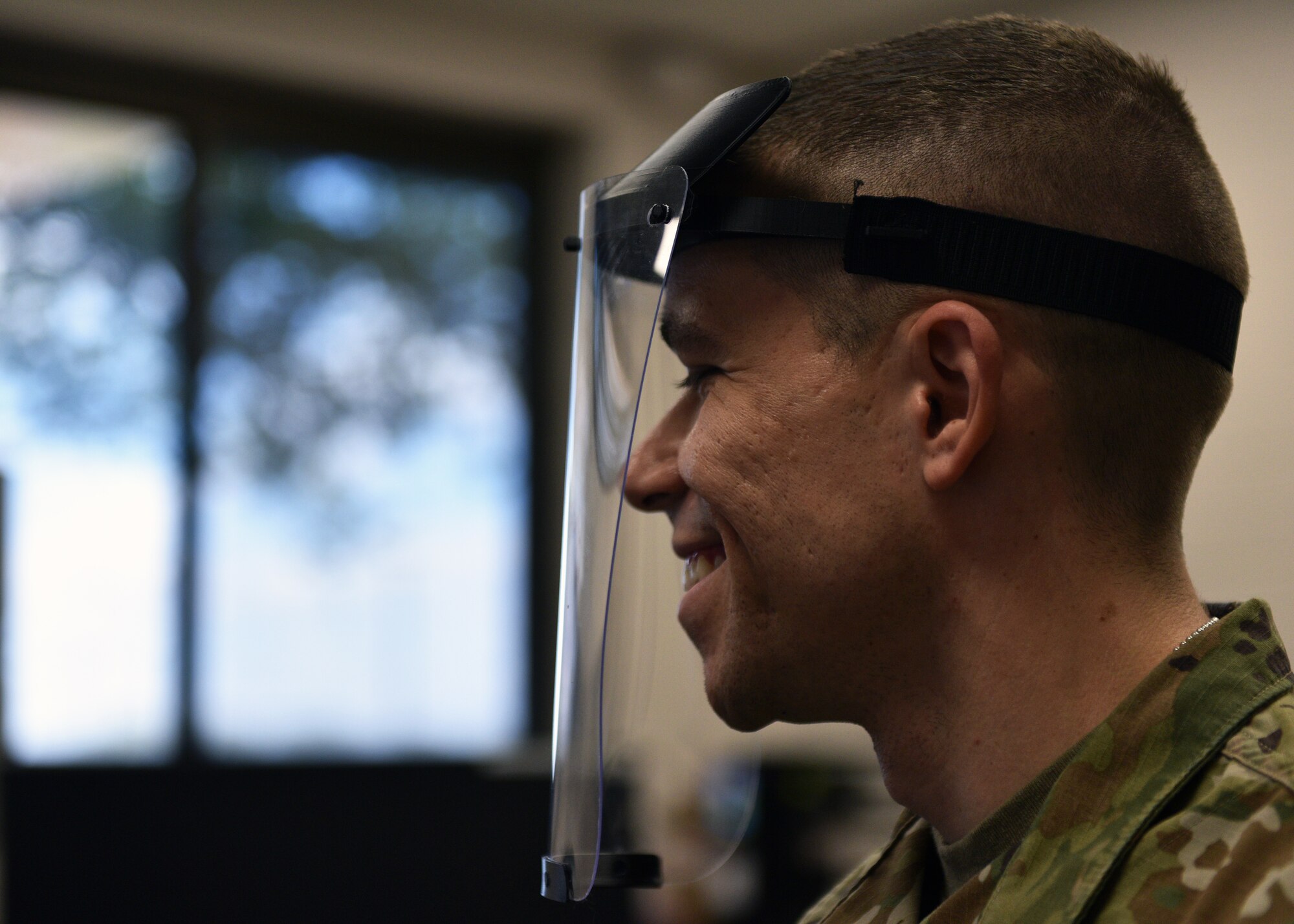 U.S. Air Force Tech. Sgt. Donald Kramer, 312th Training Squadron Special Instruments Training course instructor supervisor, demonstrates a prototype of a 3D printed face shield at the Louis F Garland Department of Defense Fire Academy on Goodfellow Air Force Base, Texas, March 31, 2020. Kramer, as well as other SPINSTRA instructors, own personal 3-D printers, providing more resources to the project. (U.S. Air Force photo by Airman 1st Class Robyn Hunsinger)