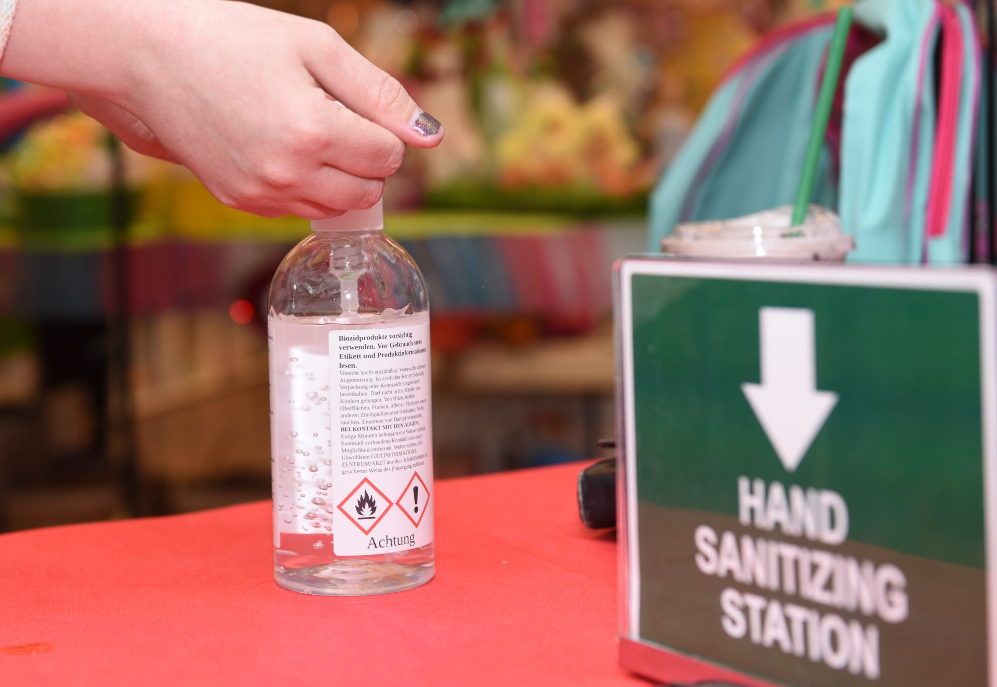 A Ramstein Base Exchange customer uses a hand sanitizing station to prevent the spread of coronavirus disease 2019 at Ramstein Air Base, Germany, April 21, 2020.