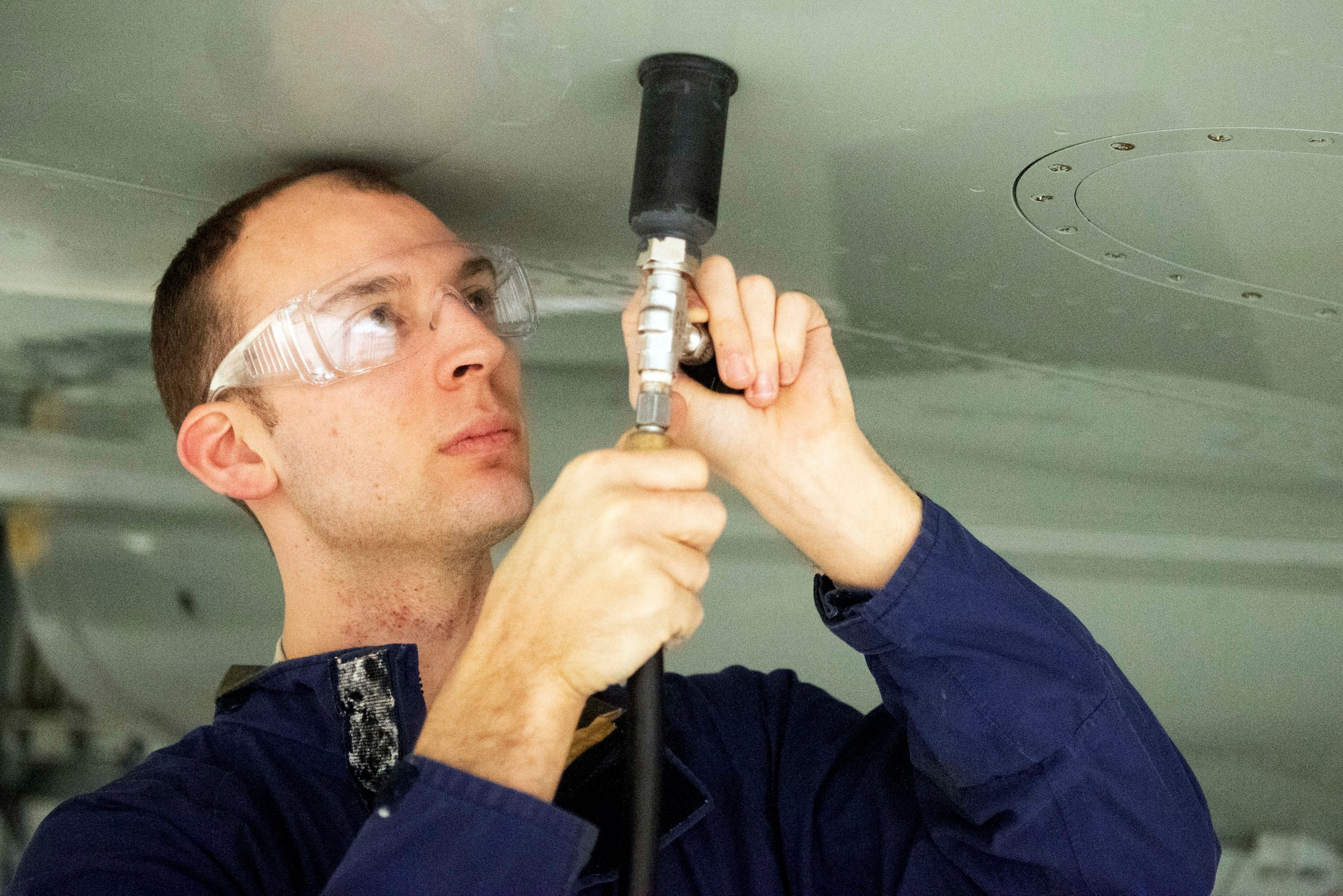 Staff Sgt. Patrick Leach, 100th Maintenance Squadron aircraft fuels systems craftsman, uses the Pressurized Leak Detection Cup he designed Feb. 14, 2020, at RAF Mildenhall, England. The device has reduced leak detection time in fuel tanks by 75 percent and can potentially save the base more than $1 million annually. (U.S. Air Force photo by Airman 1st Class Joseph Barron)