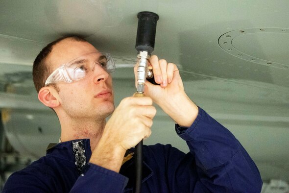Staff Sgt. Patrick Leach, 100th Maintenance Squadron aircraft fuels systems craftsman, uses the Pressurized Leak Detection Cup he designed Feb. 14, 2020, at RAF Mildenhall, England. The device has reduced leak detection time in fuel tanks by 75 percent and can potentially save the base more than $1 million annually. (U.S. Air Force photo by Airman 1st Class Joseph Barron)
