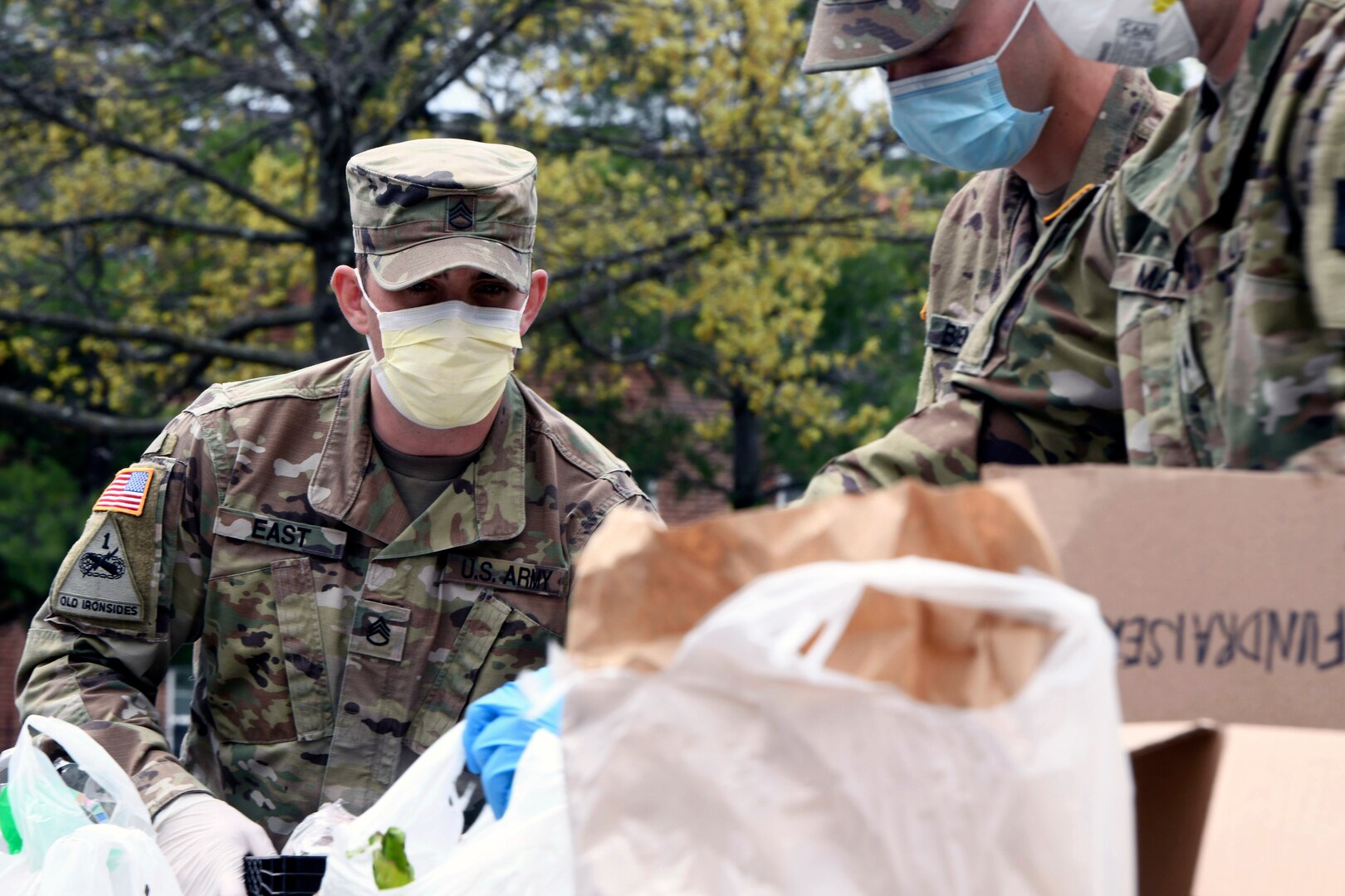 Army Staff Sgt. Bryant East, a squad leader with the Maryland Army National Guard’s Company A, 1st Battalion, 175th Infantry Regiment, helps organize food and toiletries at a parking lot in Frederick, Maryland, April 23, 2020, while distributing food to those who need it as part of COVID-19 response efforts. East, along with approximately 30 other Soldiers from the unit, were augmenting food bank volunteers and staff members.
