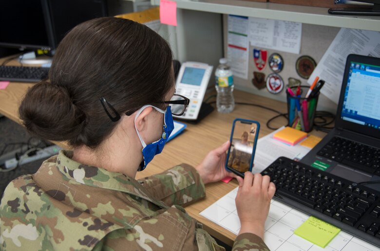 Capt. Katie Saunders, 919th Special Operations Medical Squadron, chief of public health, attends a virtual morning meeting at Duke Field, Fla., April 13, 2020.