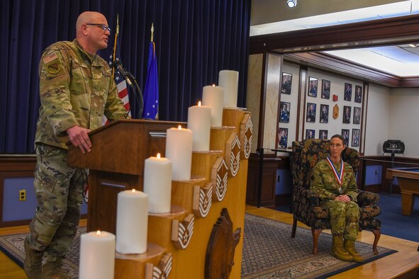 Chief Master Sgt. Rebecca Marrs, 66th Medical Squadron Operations Flight superintendent, listens as Chief Master Sgt. Michael Daly, interim installation command chief, speaks during the chief induction ceremony at Hanscom Air Force Base, Mass., April 29. Marrs was officially promoted during the ceremony. (U.S. Air Force photo by Mark Herlihy)
