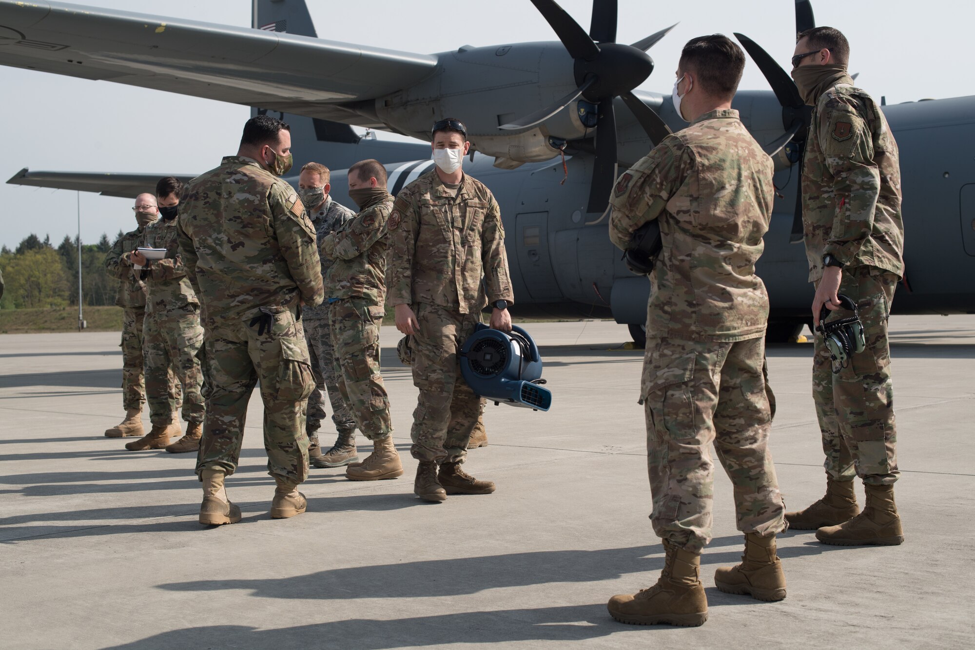 Airman carrying an ion distribution unit.