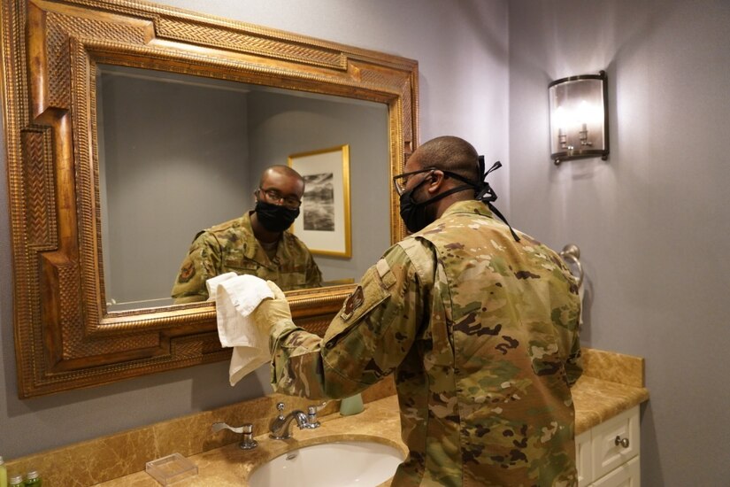 Senior Airman Kayce Swanigan, of Littlerock, Ark., cleans a mirror April 14, 2020 at Dover Air Force Base, Del.