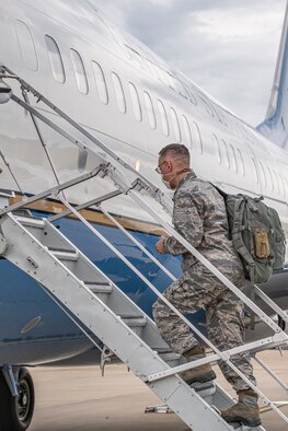 Photo of airman boarding flight.