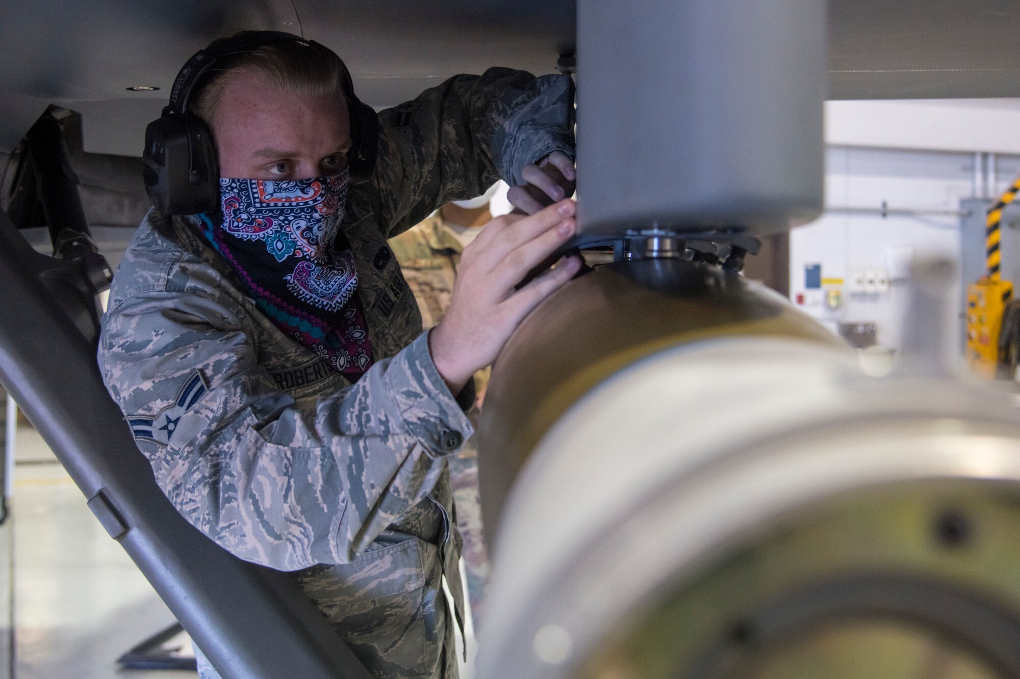 Airman 1st Class Richard Robertson, 9th Aircraft Maintenance Unit weapons load crew member, inspects a munition at the first quarter load competition April 28, 2020, at Holloman Air Force Base, N.M. Airmen used various tools and equipment during the competition to complete the mission of arming either an MQ-9 Reaper or F-16 Viper while racing against the clock with the opposing team. This event aids in enhancing Airmen’s readiness, performance and technical abilities. (U.S. Air Force photo by Senior Airman Collette Brooks)