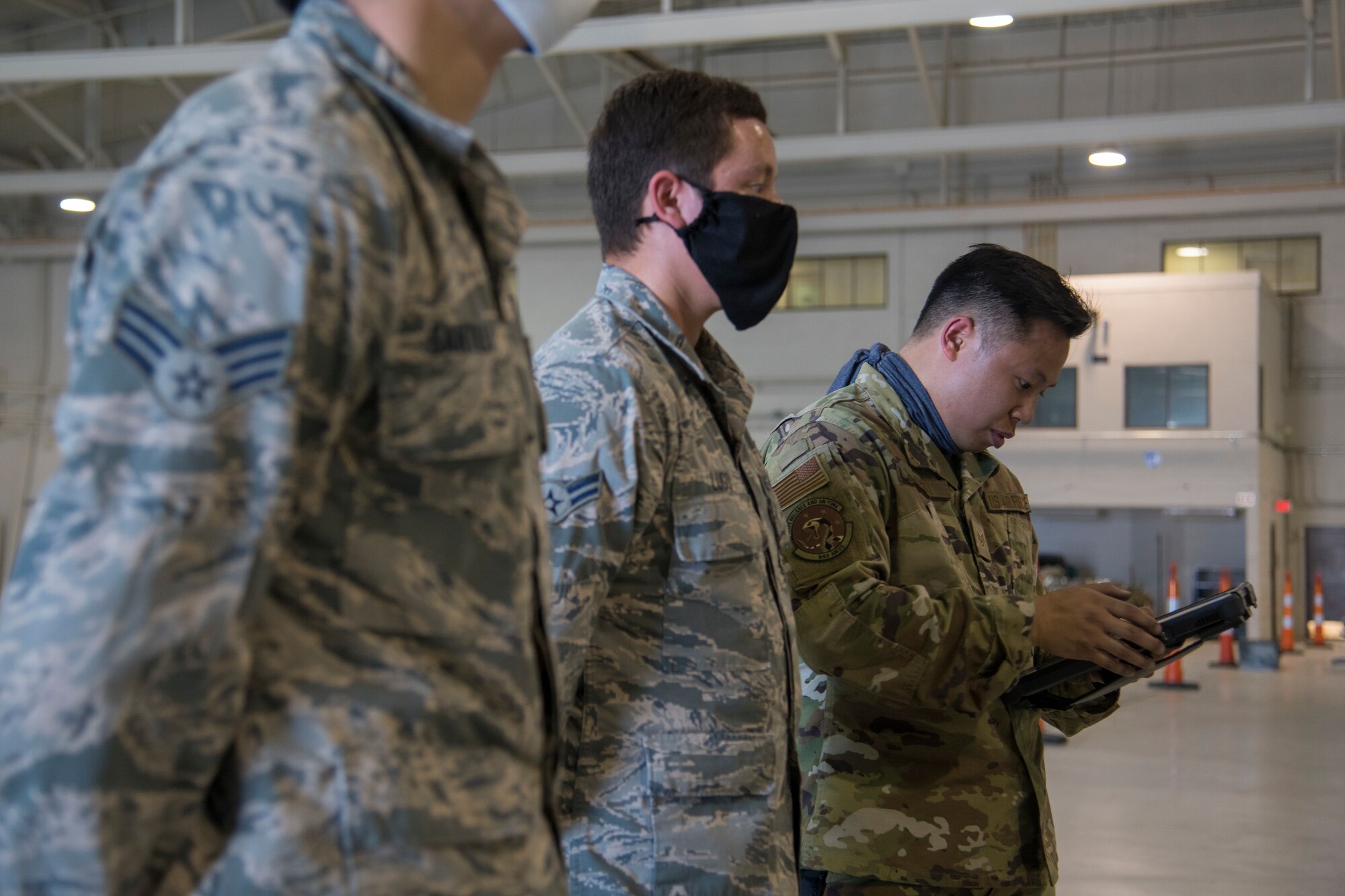 Staff Sgt. Gabriel Bongat, 314th Aircraft Maintenance Unit weapons load crew chief, reviews technical orders on a tablet during the first quarter load competition April 28, 2020, at Holloman Air Force Base, N.M. Airmen used various tools and equipment during the competition to complete the mission of arming an F-16 Viper and an MQ-9 Reaper while racing against the clock and an opposing team. (U.S. Air Force photo by Senior Airman Collette Brooks)