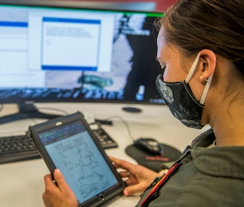 Capt. Sophia Schmidt, 16th Airlift Squadron Operations Support Flight assistant flight commander, reviews plans for a local training flight at Joint Base Charleston, S.C., April 29, 2020.