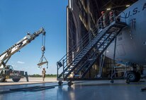 Airmen assigned to the 437th Aircraft Maintenance Squadron install a new window in the flightdeck of a C-17 Globemaster III aircraft at Joint Base Charleston, S.C., April 28, 2020. The 437th AMXS is still generating aircraft to support local training flights, missions from Air Mobility Command and supporting training for aeromedical evacuation personnel while being critically manned during the COVID-19 pandemic. The 437th AMXS is also implementing physical distancing when possible and following other Centers for Disease Control guidelines. Additionally, they have trained some of their personnel to decontaminate aircraft before and after missions to keep aircrews and 437th AMXS personnel safe. (U.S. Air Force Photo by Staff Sgt. Megan Munoz)