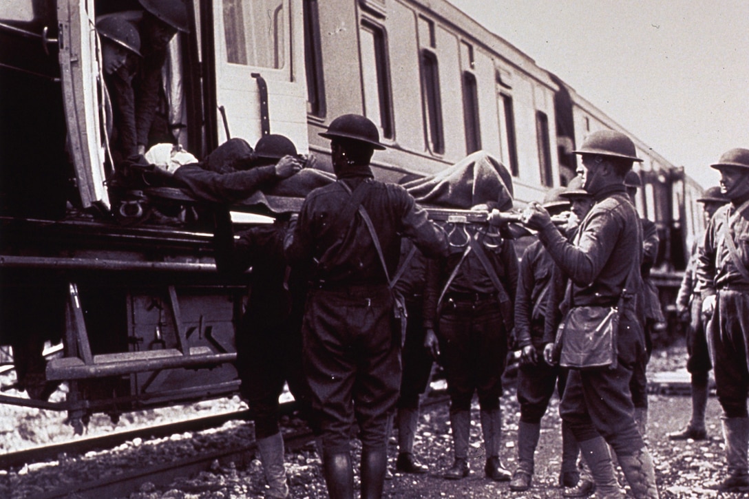 Troops load injured soldiers onto a World War I-era train