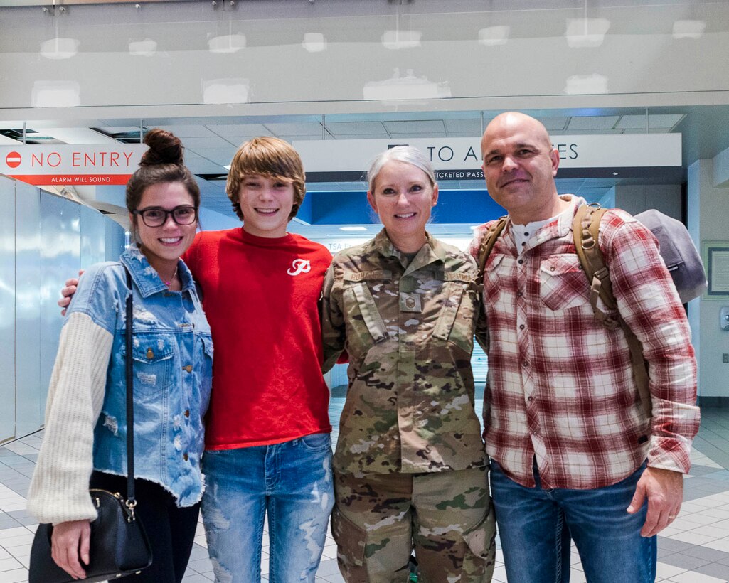 Senior Master Sgt. Joy Rohauer reunites with her family after a deployment as the Air Force Central Command's occupational safety superintendent, Jan. 2020. During her deployment she visited various bases to inspect programs that ensure the health and safety of military personnel. (U.S. Air Force Reserve photo by Maj. Ashley Walker)