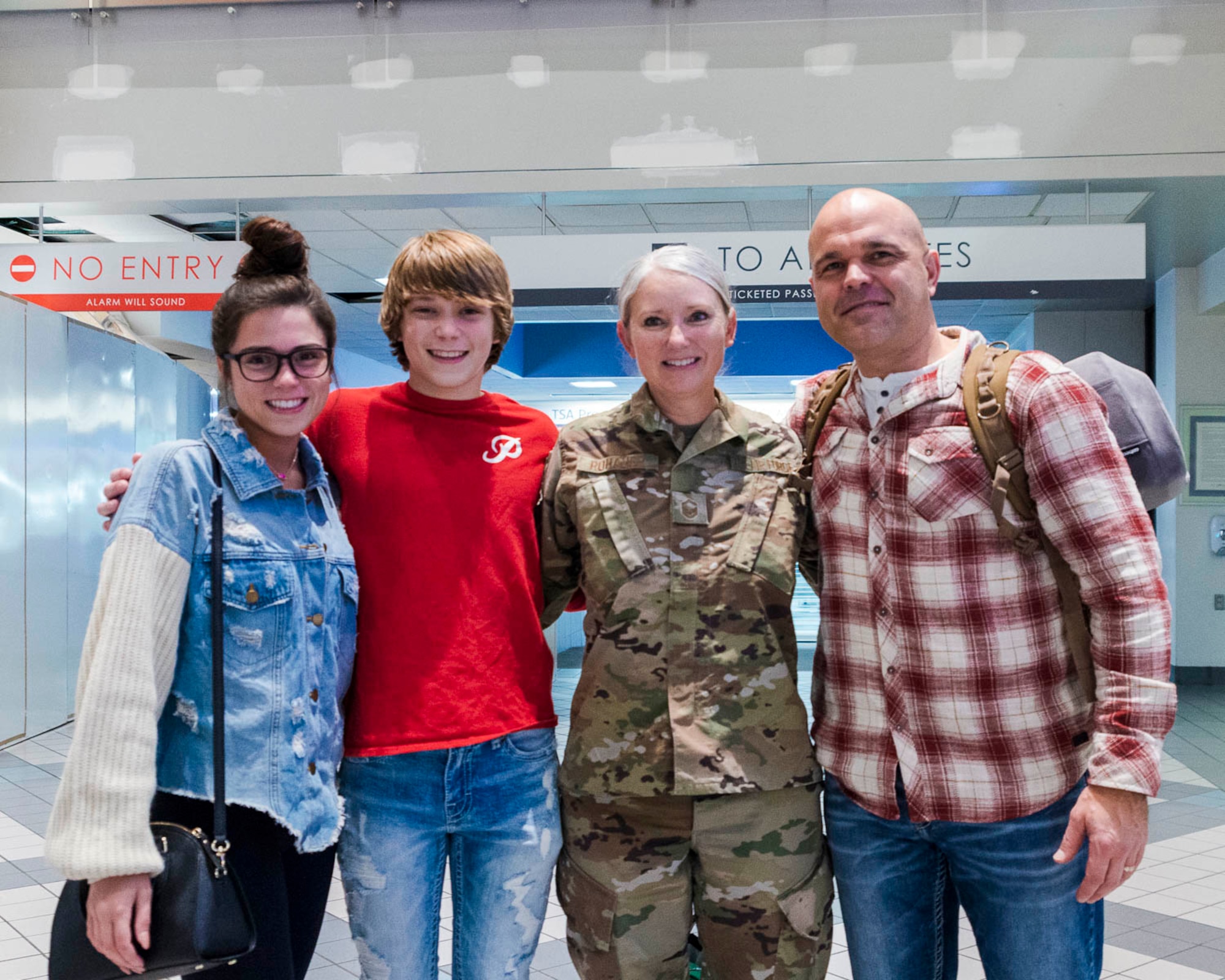 Senior Master Sgt. Joy Rohauer reunites with her family after a deployment as the Air Force Central Command's occupational safety superintendent, Jan. 2020. During her deployment she visited various bases to inspect programs that ensure the health and safety of military personnel. (U.S. Air Force Reserve photo by Maj. Ashley Walker)