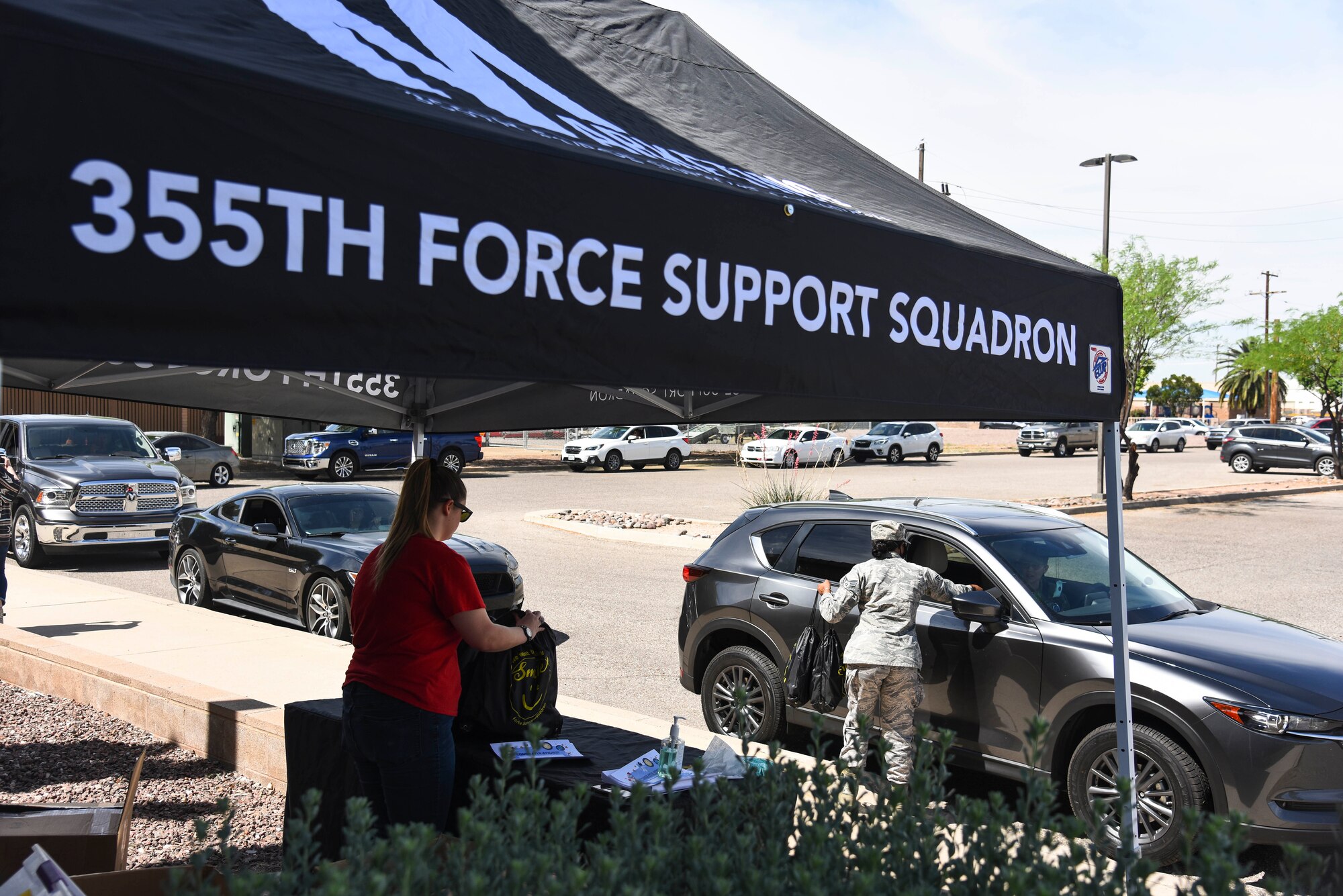 A photo of an Airman passing out bags of free toys to celebrate the Month of the Military Child.