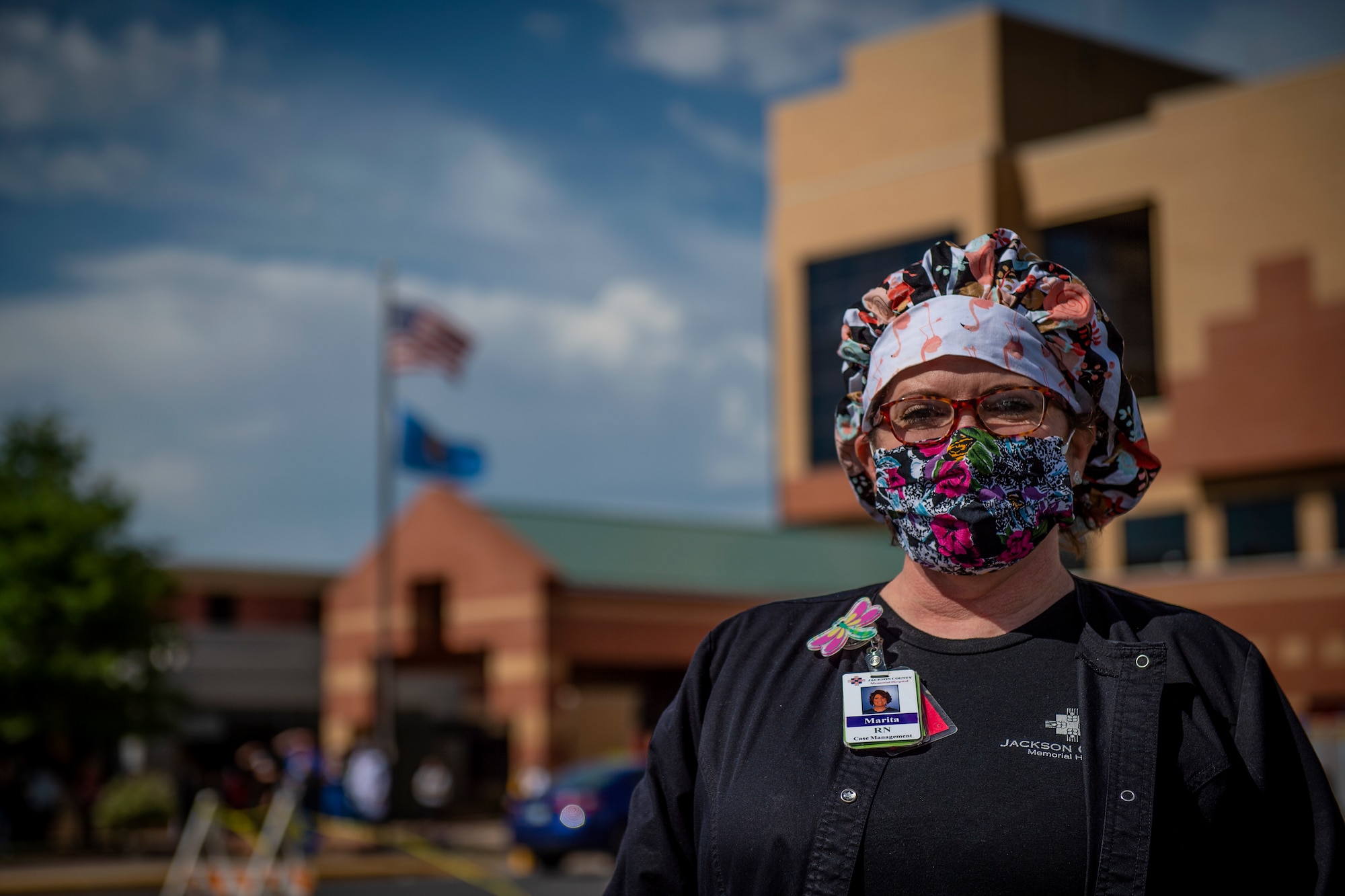 Marita Chapa, a Registered Nurse with Jackson County Memorial Hospital (JCMH), waits for a flyover to begin at JCMH in Altus, Oklahoma, May 1, 2020.