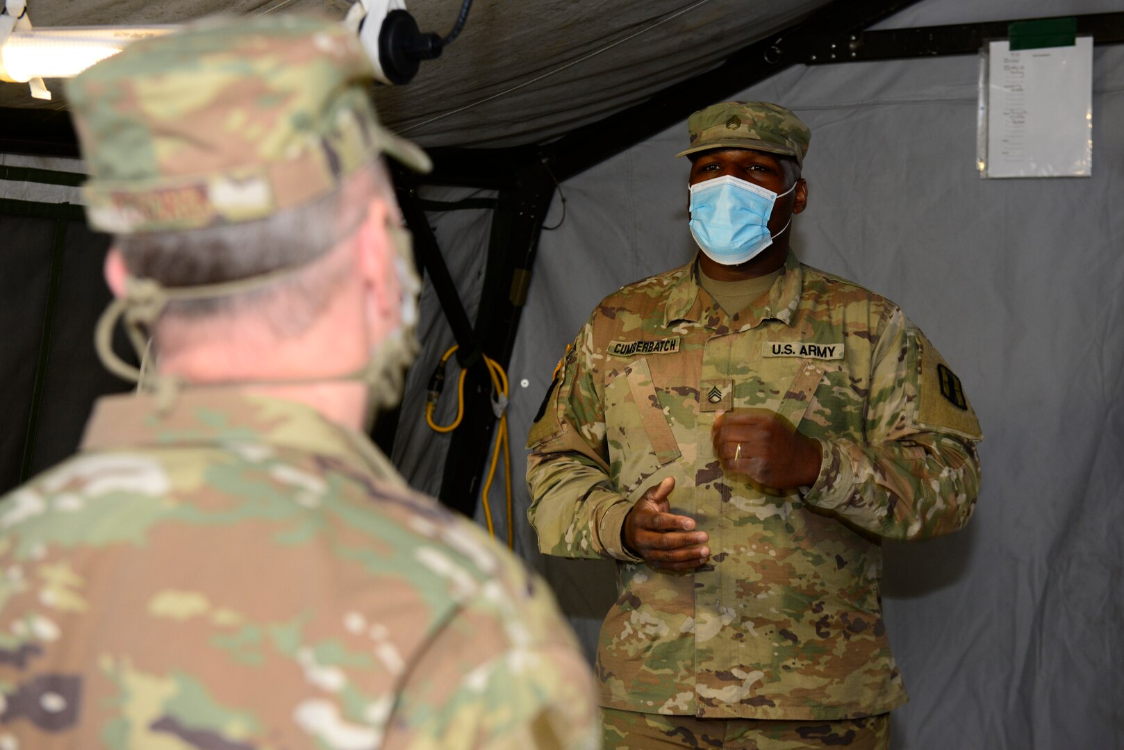 Staff Sgt. Adam Cumberpatch, motor transportation operator, 744th Forward Support Company, New Hampshire Army National Guard, briefs Col. John Pogorek, 157th Air Refueling Wing Commander, on the COVID-19 testing process, May 1, 2020, at the New Hampshire Army National Guard Readiness Center in Rochester, N.H.