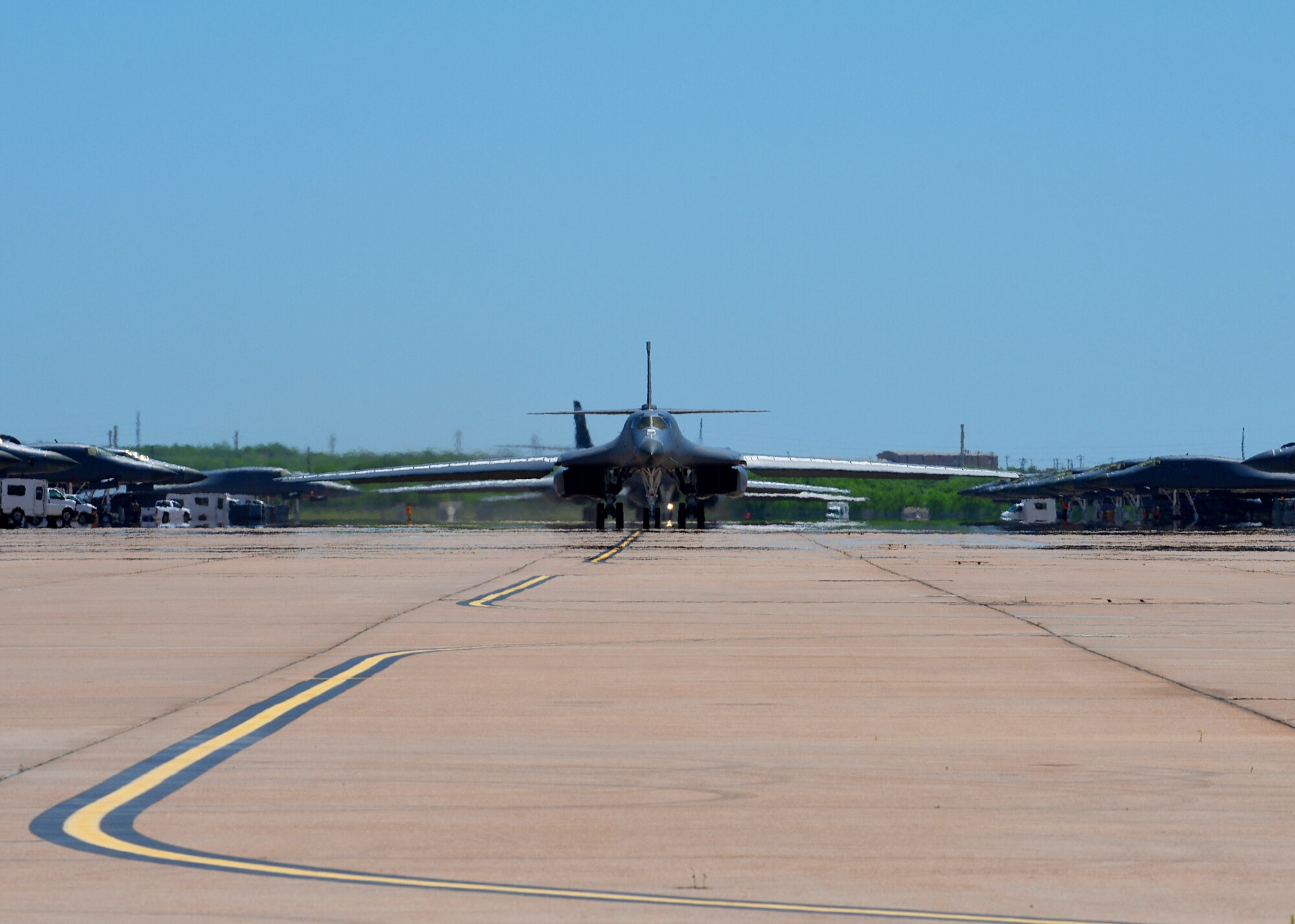 A line of B-1B Lancers from the 9th Bomb Squadron taxi before departing on a Bomber Task Force deployment at Dyess Air Force Base, Texas, April 30, 2020. A BTF of four B-1s and approximately 200 Airmen deployed to Andersen Air Force Base, Guam, as part of the Air Force’s dynamic force employment initiative. (U.S. Air Force photo by Senior Airman Mercedes Porter)