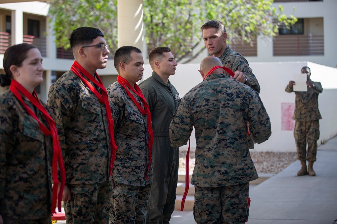 U.S. Marines assigned to Marine Corps Air Station (MCAS) Yuma, Headquarters and Headquarters Squadron (H&HS), receive their blood stripe during the H&HS Blood Stripe Ceremony at MCAS Yuma, Ariz., March 2, 2020. The blood stripe honors the blood that was shed by Marine officers and noncommissioned officers during the Battle of Chapultepec in 1847. (U.S. Marine Corps photo by LCpl. Gabrielle Sanders)
