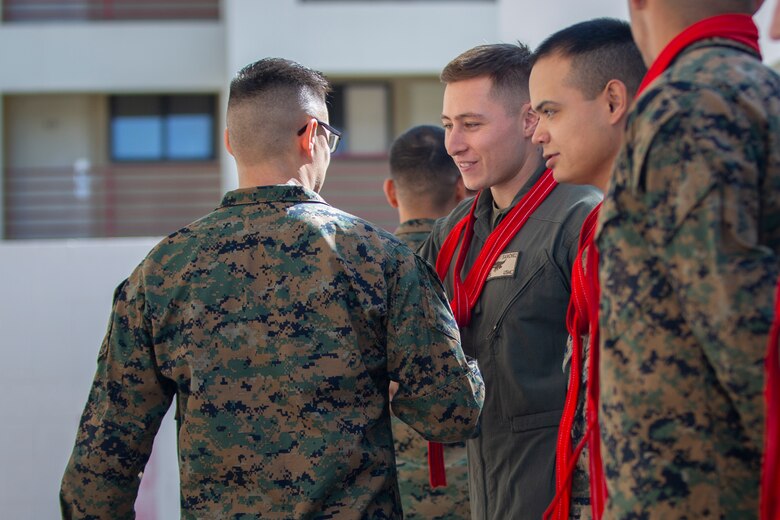 U.S. Marines assigned to Marine Corps Air Station (MCAS) Yuma, Headquarters and Headquarters Squadron (H&HS), receive their blood stripe during the H&HS Blood Stripe Ceremony at MCAS Yuma, Ariz., March 2, 2020. The blood stripe honors the blood that was shed by Marine officers and noncommissioned officers during the Battle of Chapultepec in 1847. (U.S. Marine Corps photo by LCpl. Gabrielle Sanders)