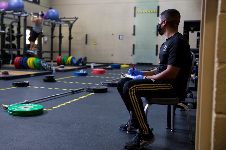 A gym employee keeps track of how many patrons are in each room at the station gym on Marine Corps Air Station Yuma, April 30, 2020. The gym reopened with extra precautions set in place to keep service members and gym employees safe. (U.S. Marine Corps Photo by Cpl. Nicole Rogge)