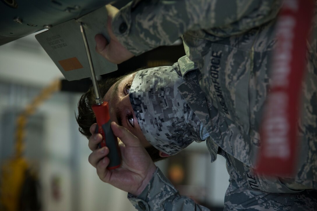 Airman 1st Class Dalton Hottle, 9th Aircraft Maintenance Unit weapons load crew member, tightens a screw on an MQ-9 Reaper during the first quarter load competition April 28, 2020, at Holloman Air Force Base, N.M. The competition participants were evaluated and scored based on munitions loading accuracy, infractions, tool accountability, and dress and appearance. (U.S. Air Force photo by Senior Airman Collette Brooks)