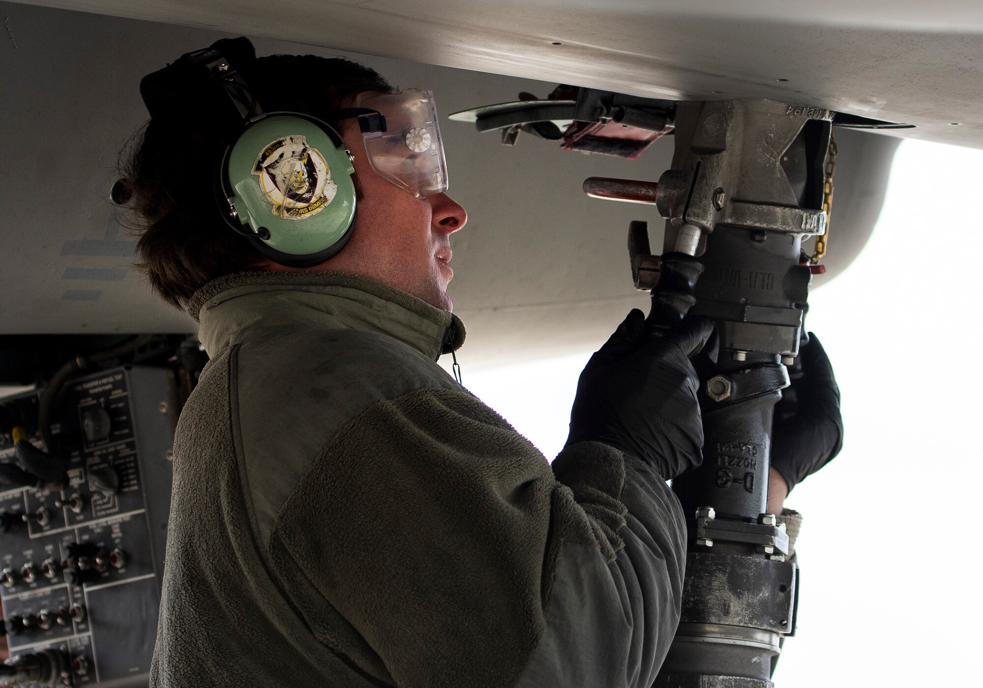 A 48th Maintenance Group crew chief hooks up the mobile pantograph to an F-15C Eagle to perform "hot pit" refueling operations at Royal Air Force Lakenheath, England, April 30, 2020. Crew chiefs work closely with 48th Logistics Readiness Squadron Airmen to deliver over 350,000 gallons of JP-8 fuel per week, keeping the Liberty Wing ready to deliver combat airpower despite the current COVID-19 pandemic. (U.S. Air Force photo by Airman 1st Class Jessi Monte)