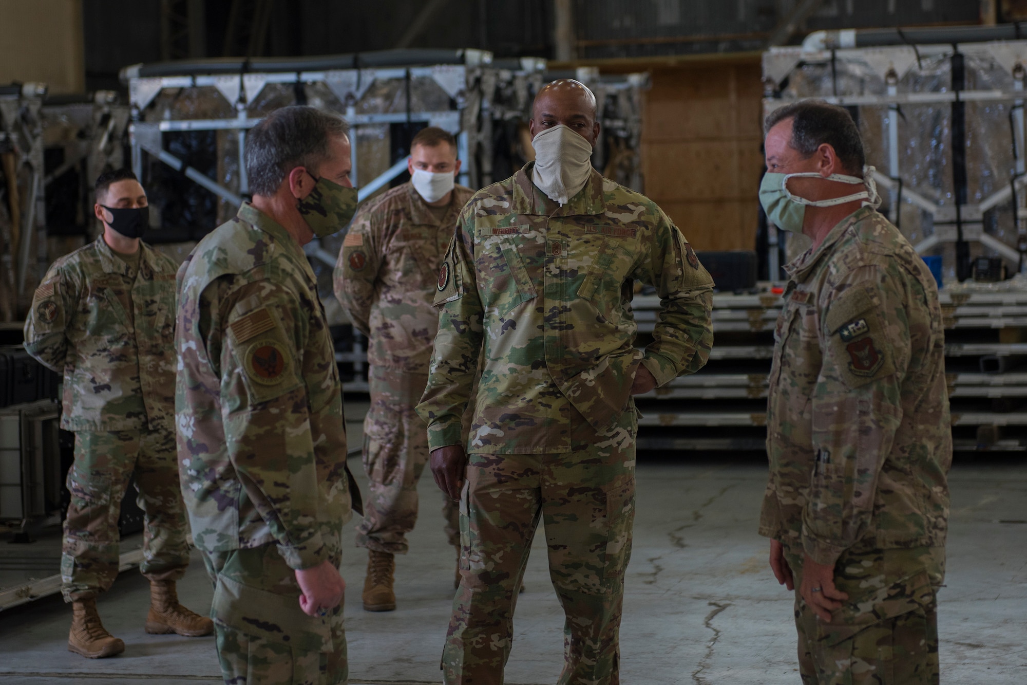 Chief of Staff of the Air Force Gen. David L. Goldfein, left, and Chief Master Sgt. of the Air Force Kaleth O. Wright, center, discuss the Transport Isolation System with Col. Adam Willis, 315th Airlift Wing Commander, right, at Joint Base Charleston, S.C., April 30, 2020. Goldfein and Wright were at JB Charleston to observe current aeromedical evacuation TIS operations and Palmetto Spark, JB Charleston’s innovation cell. The TIS is a system designed to safely transport infectious patients by aircraft and is being used as part of the Department of Defense’s COVID-19 response. Palmetto Spark allows Airmen to get help with coming up with innovative ideas for their squadron and has been making protective gear for non-medical personnel and hand sanitizer for units across JB Charleston. (U.S. Air Force photo by Airman Sara Jenkins)