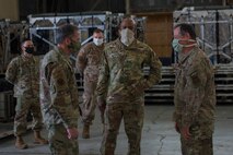 Chief of Staff of the Air Force Gen. David L. Goldfein, left, and Chief Master Sgt. of the Air Force Kaleth O. Wright, center, discuss the Transport Isolation System with Col. Adam Willis, 315th Airlift Wing Commander, right, at Joint Base Charleston, S.C., April 30, 2020. Goldfein and Wright were at JB Charleston to observe current aeromedical evacuation TIS operations and Palmetto Spark, JB Charleston’s innovation cell. The TIS is a system designed to safely transport infectious patients by aircraft and is being used as part of the Department of Defense’s COVID-19 response. Palmetto Spark allows Airmen to get help with coming up with innovative ideas for their squadron and has been making protective gear for non-medical personnel and hand sanitizer for units across JB Charleston. (U.S. Air Force photo by Airman Sara Jenkins)