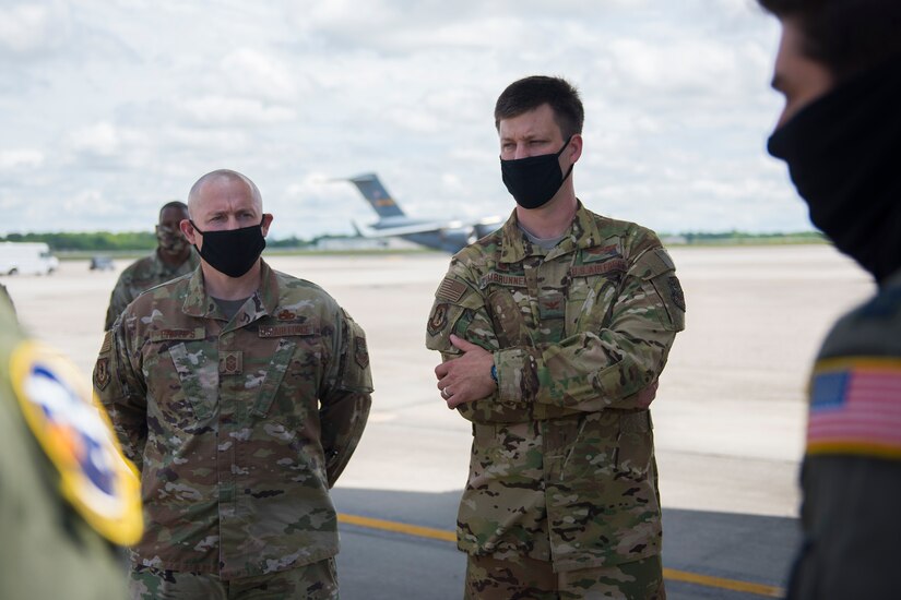 Col. Clinton ZumBrunnen, 437th Airlift Wing commander, right, and Chief Master Sgt. Ronnie Phillips, 437 AW command chief master sergeant, left, discuss the Transport Isolation System at Joint Base Charleston, S.C., April 30, 2020. Zumbrunnen and Phillips were part of a tour given to Chief of Staff of the Air Force Gen. David Goldfein, and Chief Master Sgt. of the Air Force Kaleth O. Wright, who visited JB Charleston to observe current aeromedical evacuation TIS operations and Palmetto Spark, JB Charleston’s innovation cell. The TIS is a system designed to safely transport infectious patients by aircraft and is being used as part of the Department of Defense’s COVID-19 response. Palmetto Spark allows Airmen to get help with coming up with innovative ideas for their squadron and has been making protective gear for non-medical personnel and hand sanitizer for units across JB Charleston. (U.S. Air Force photo by Airman Sara Jenkins)