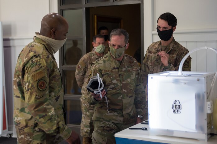Chief of Staff of the Air Force Gen. David Goldfein, the center, and Chief Master Sgt. of the Air Force Kaleth O. Wright, left, observe a mask made in the Innovation Cell at Joint Base Charleston, S.C., April 30, 2020. Goldfein and Wright were at JB Charleston to observe current aeromedical evacuation TIS operations and Palmetto Spark, JB Charleston’s innovation cell. The TIS is a system designed to safely transport infectious patients by aircraft and is being used as part of the Department of Defense’s COVID-19 response. Palmetto Spark allows Airmen to get help with coming up with innovative ideas for their squadron and has been making protective gear for non-medical personnel and hand sanitizer for units across JB Charleston. (U.S. Air Force photo by Airman Sara Jenkins)