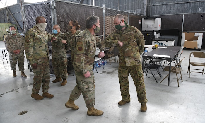 Chief of Staff of the Air Force General David L. Goldfein and Chief Master Sergeant of the Air Force Kaleth O. Wright greet Airmen after being briefed about the Transportation Isolation System at Joint Base Charleston, S.C., April 30, 2020. The senior leaders visited JB Charleston to observe many of the precautions and systems being used in response to the current COVID-19 situation (U.S. Air Force photo by Senior Airman Cody R. Miller)