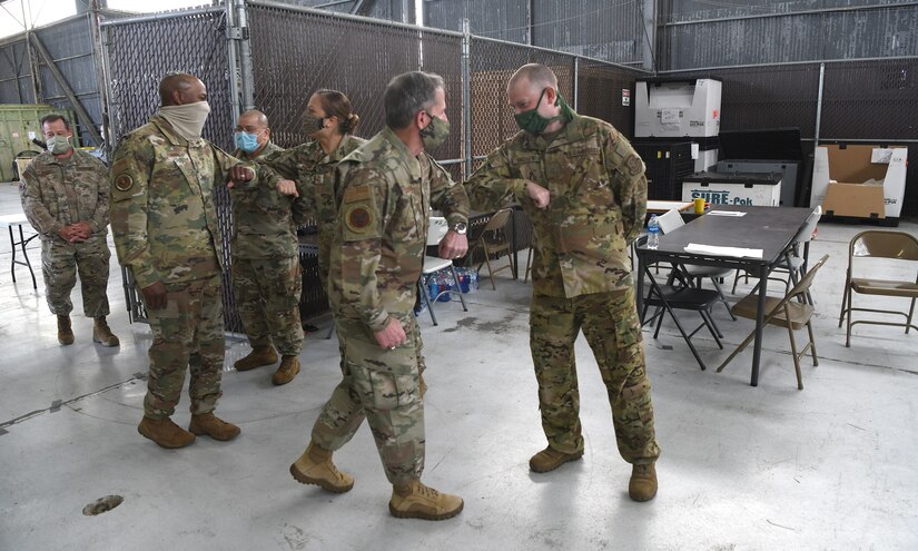 Chief of Staff of the Air Force General David L. Goldfein and Chief Master Sergeant of the Air Force Kaleth O. Wright greet Airmen after being briefed about the Transportation Isolation System at Joint Base Charleston, S.C., April 30, 2020. The senior leaders visited JB Charleston to observe many of the precautions and systems being used in response to the current COVID-19 situation (U.S. Air Force photo by Senior Airman Cody R. Miller)